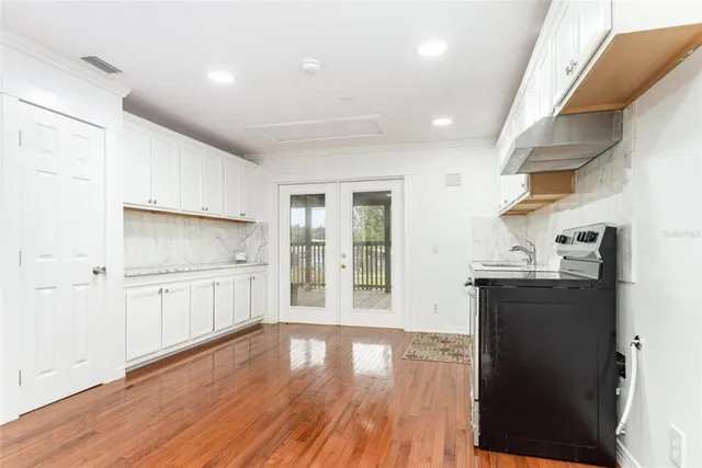 a kitchen with a refrigerator and a stove top oven