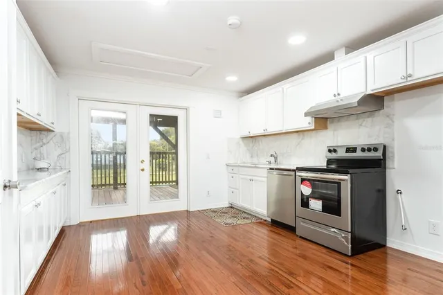 a kitchen with a stove top oven and a refrigerator