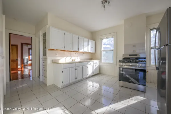 a kitchen with a refrigerator a stove a sink and a window