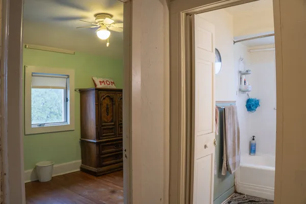 a view of hallway with a mirror and a window