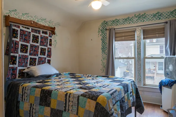 a bedroom with a bed and a window