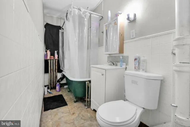 a white toilet sitting next to a bathroom sink