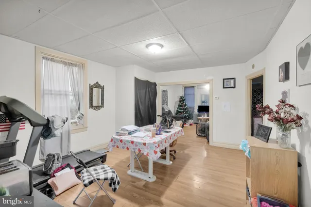 a living room with furniture a dining table and large windows