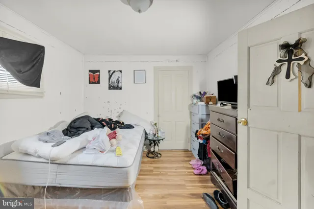 a bedroom with furniture and a flat screen tv