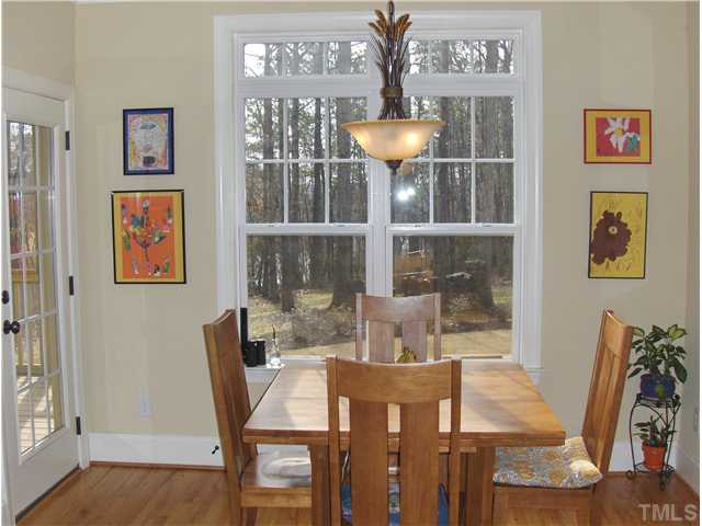 1716 Struble Circle Willow Spring, NC 27592 - Photo 11 of 25 a view of a dining room with furniture and wooden floor