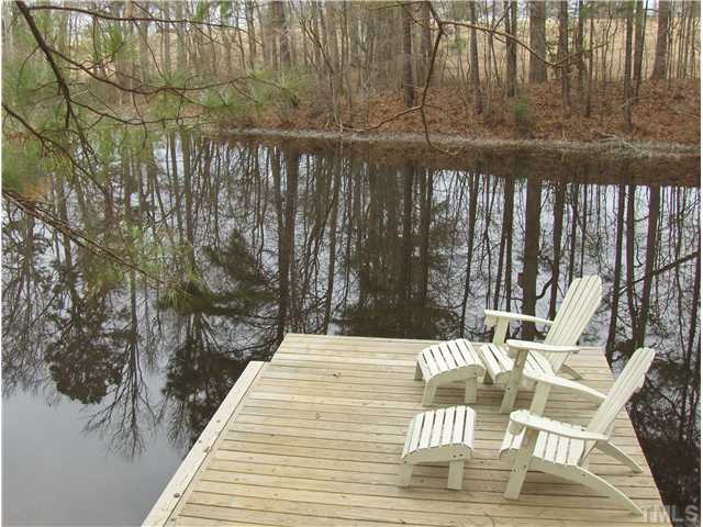 1716 Struble Circle Willow Spring, NC 27592 - Photo 23 of 25 a patio with table and chairs and wooden floor