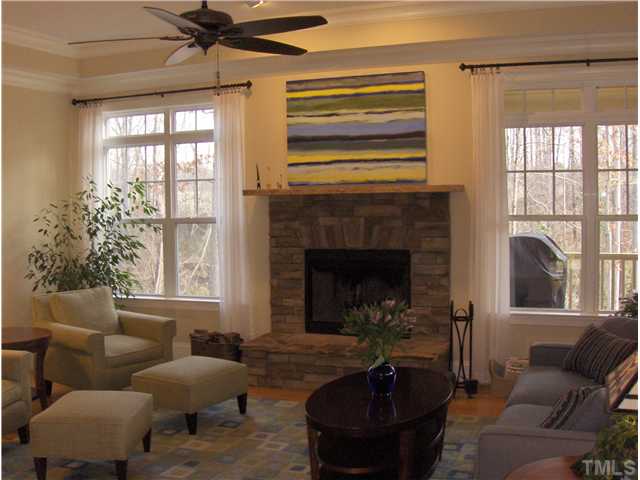 1716 Struble Circle Willow Spring, NC 27592 - Photo 8 of 25 a living room with furniture windows and a fireplace