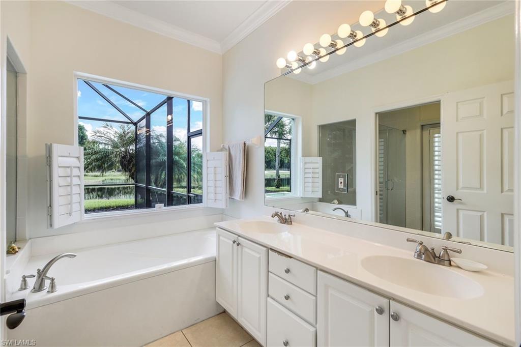 17983 Modena Road Miromar Lakes, FL 33913 - Photo 15 of 44 Master Bathroom with pool access featuring tile flooring, dual vanity, plus walk in shower, and crown molding