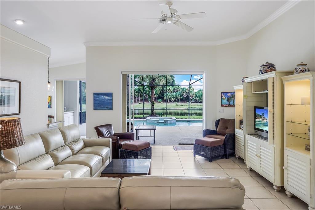 17983 Modena Road Miromar Lakes, FL 33913 - Photo 3 of 44 Living room with light tile flooring, crown molding, and ceiling fan