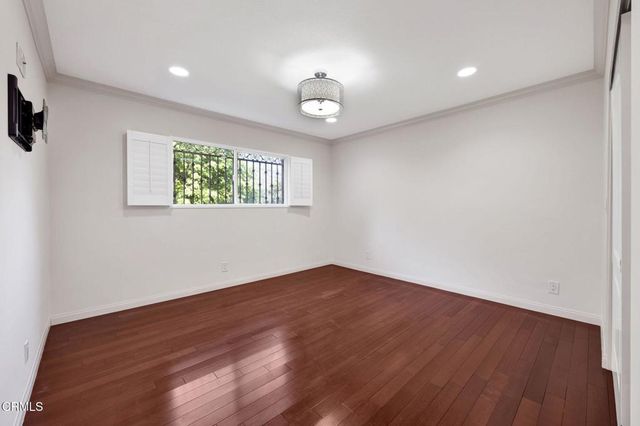 a bathroom with a granite countertop sink a toilet a mirror and shower