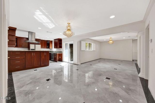 a view of a kitchen with a sink and cabinets