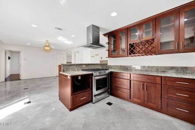 a kitchen with stainless steel appliances granite countertop a stove and a sink