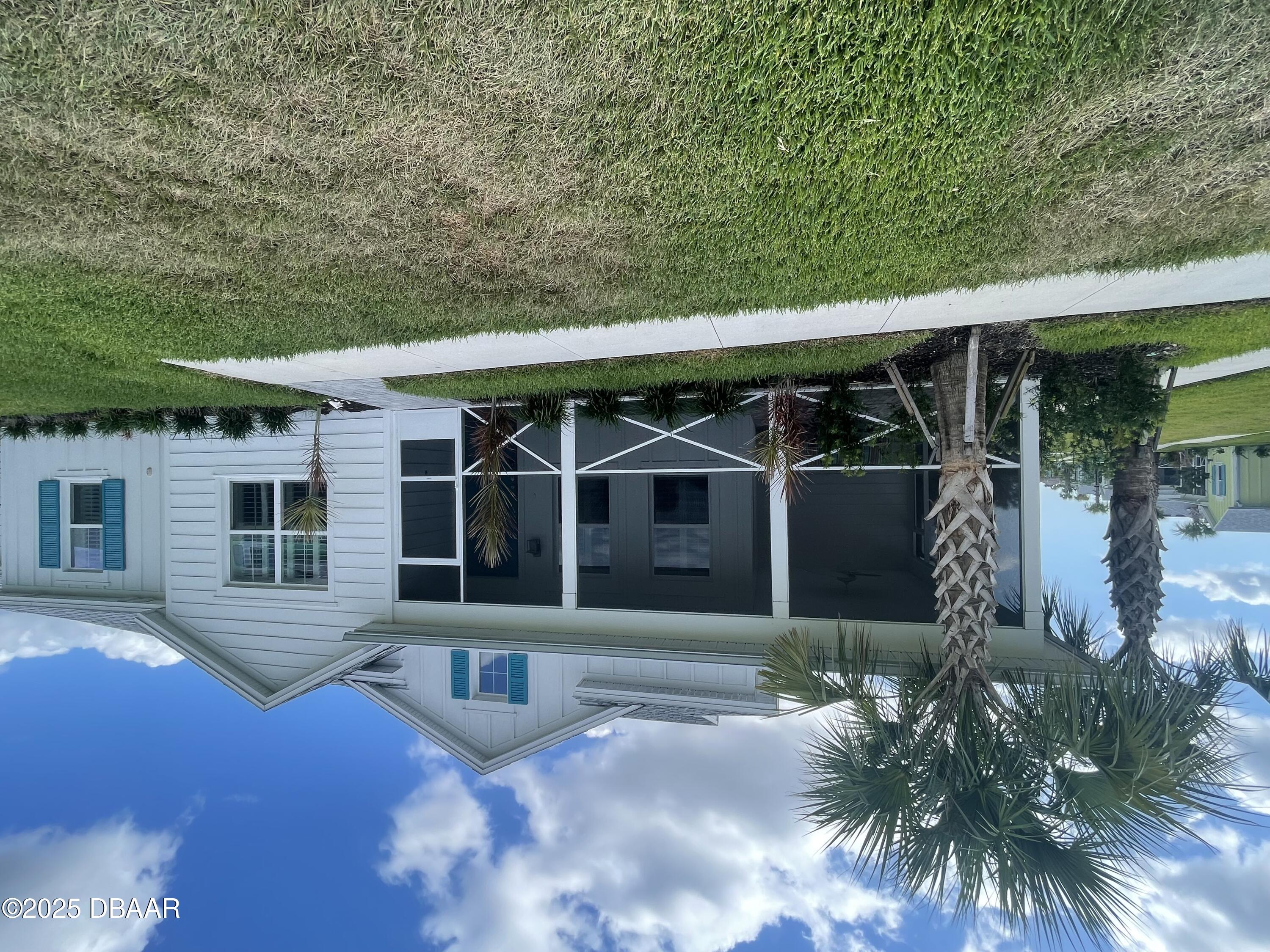 231 Ocean Hammock Loop Daytona Beach, FL 32124 - Photo 1 of 39 a view of a house with a yard and plants