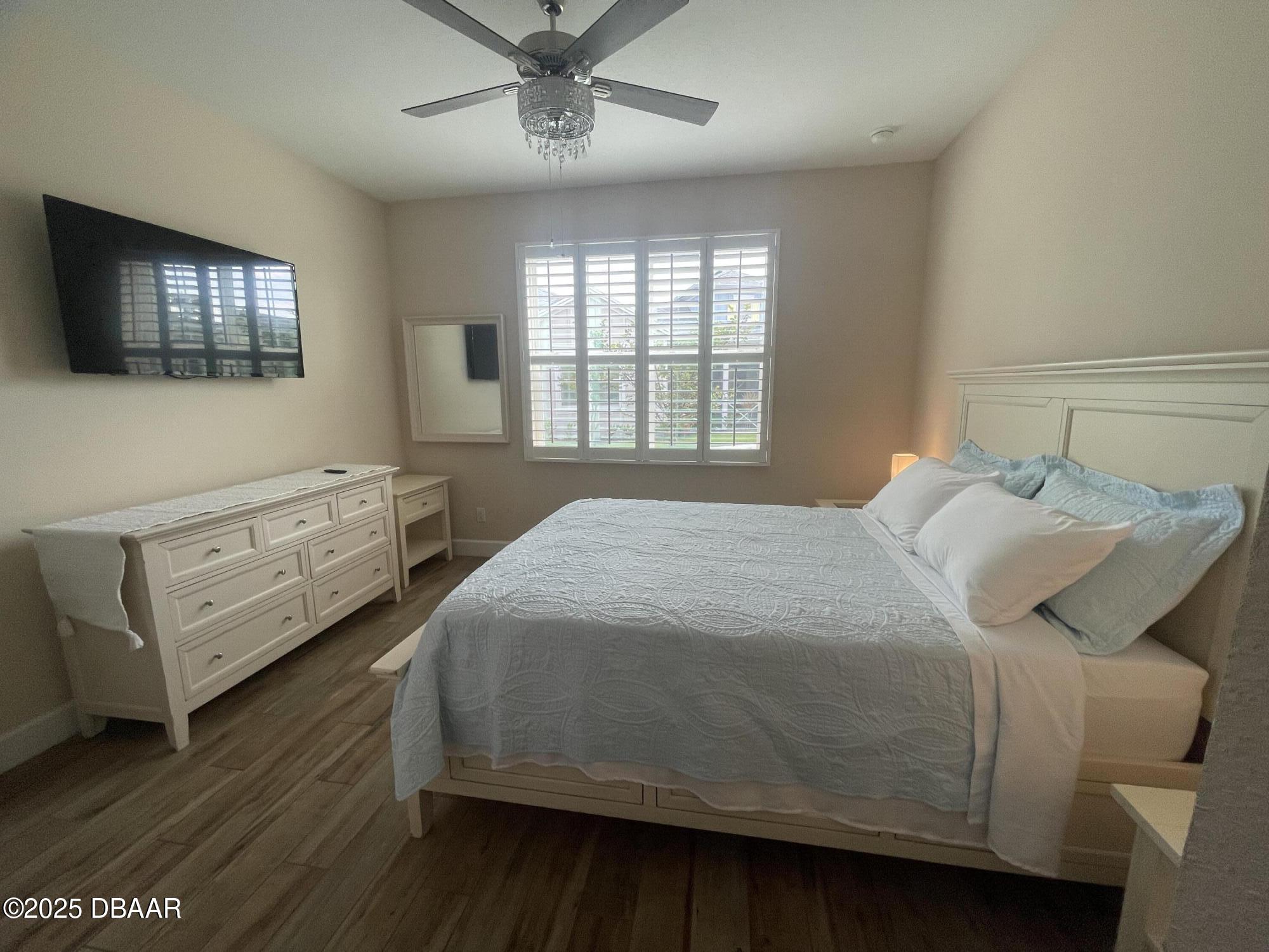 231 Ocean Hammock Loop Daytona Beach, FL 32124 - Photo 12 of 39 a bedroom with a bed and a flat screen tv