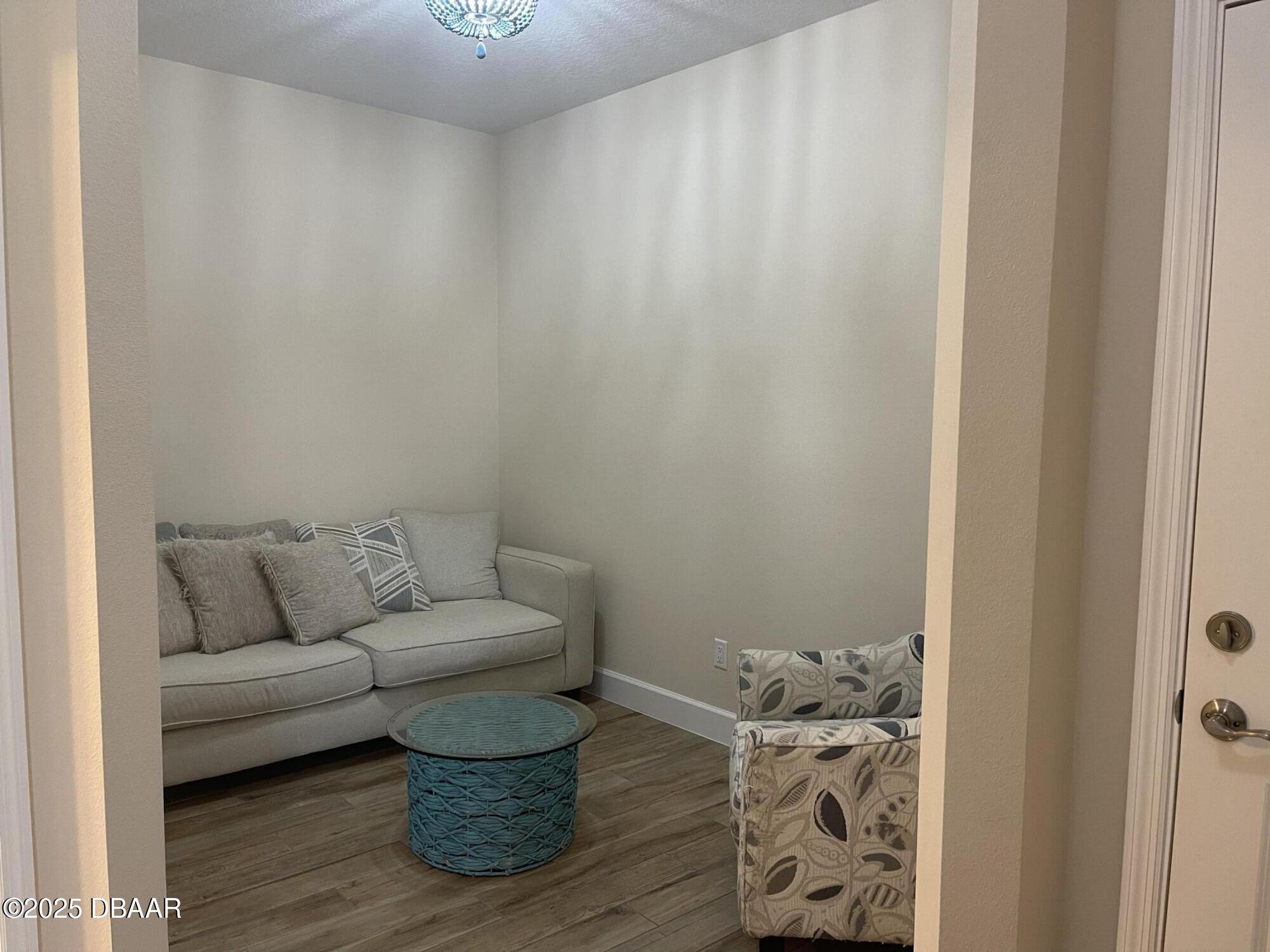 231 Ocean Hammock Loop Daytona Beach, FL 32124 - Photo 18 of 39 a living room with furniture and a wooden floor