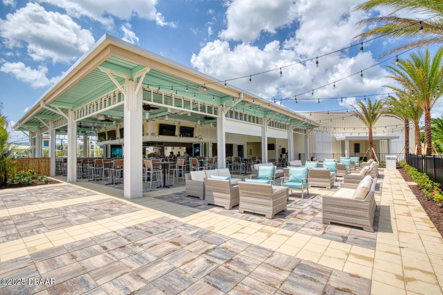 231 Ocean Hammock Loop Daytona Beach, FL 32124 - Photo 30 of 39 a view of a patio with a dining table and chairs with wooden floor