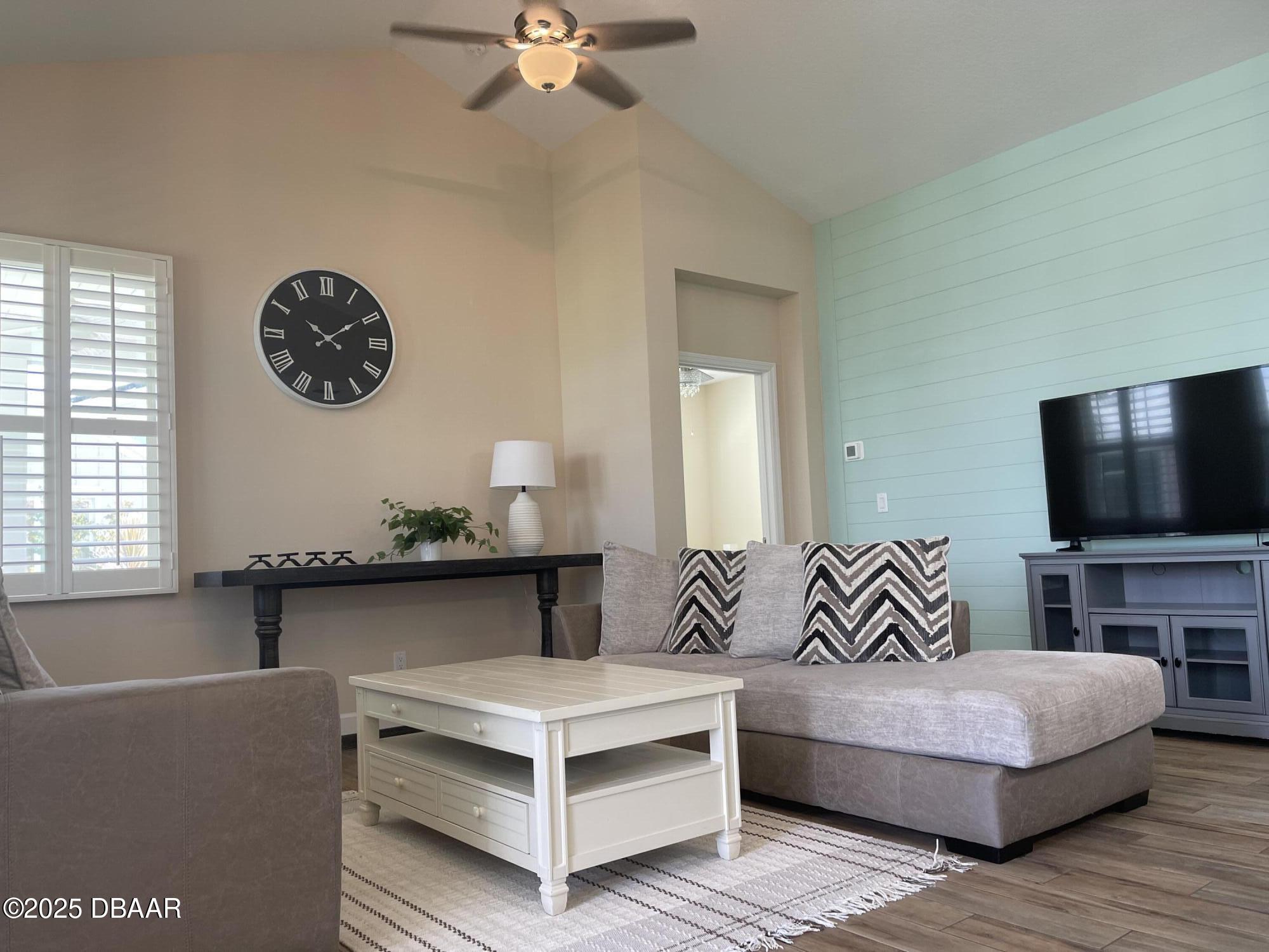 231 Ocean Hammock Loop Daytona Beach, FL 32124 - Photo 9 of 39 a living room with furniture and a flat screen tv