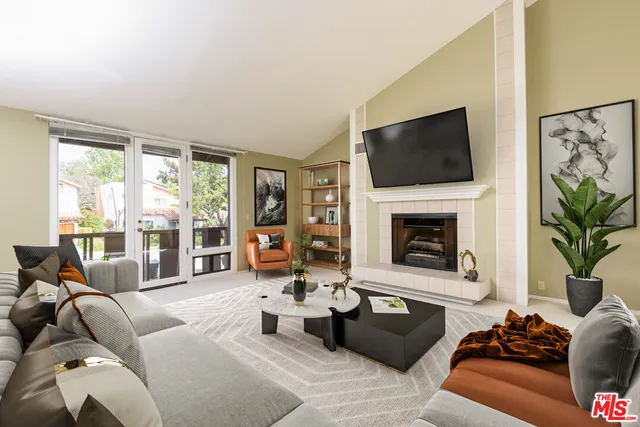 a living room with furniture fireplace and flat screen tv
