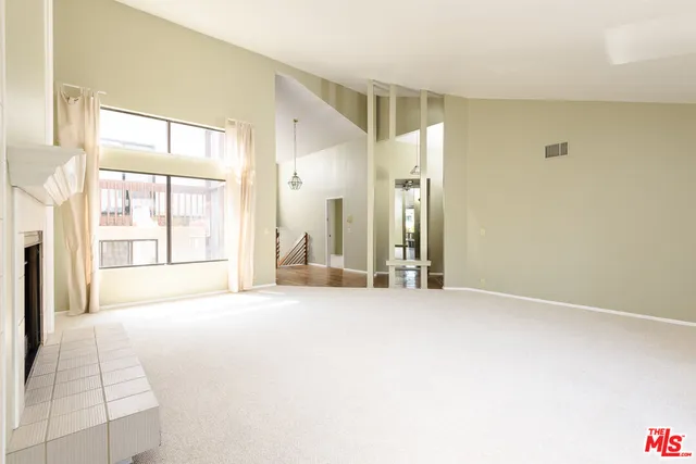 a view of an empty room with large window