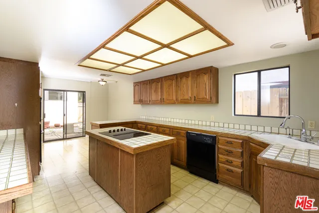 a kitchen that has a sink and a stove in it
