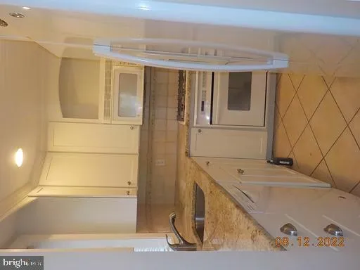 a bathroom with a tub and a window