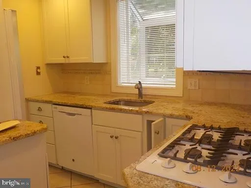 a kitchen with a sink and wooden cabinets