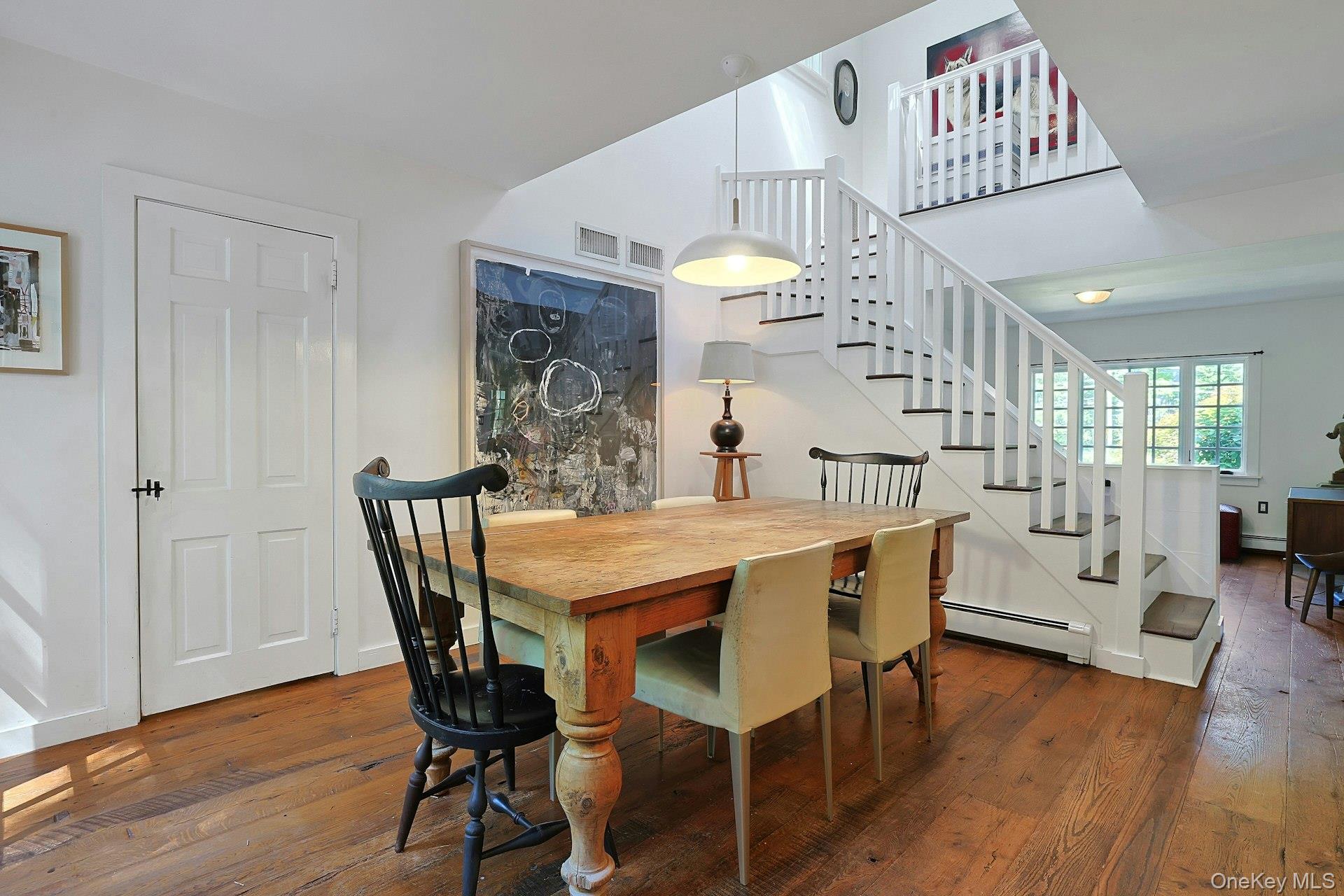 65 Douglas Road Chappaqua, NY 10514 - Photo 14 of 41 The dining area flows naturally toward the staircase, creating a bright and open connection between the home’s main living spaces and the second floor.