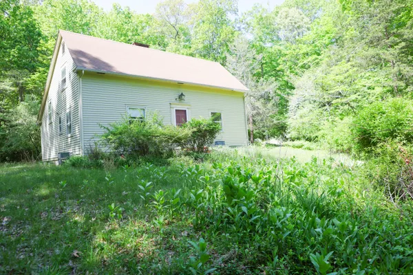 a view of a house with a yard and plants