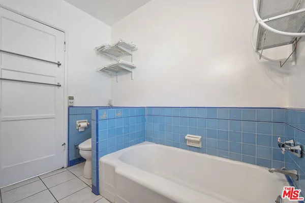 a bathroom with a bathtub and a toilet
