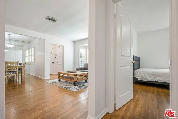 a bedroom with furniture and a wooden floor