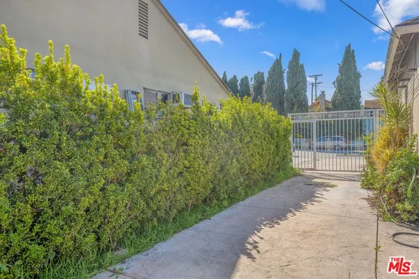 a view of a pathway both side of a house