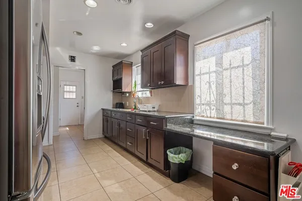 a kitchen with a cabinets and a stove top oven