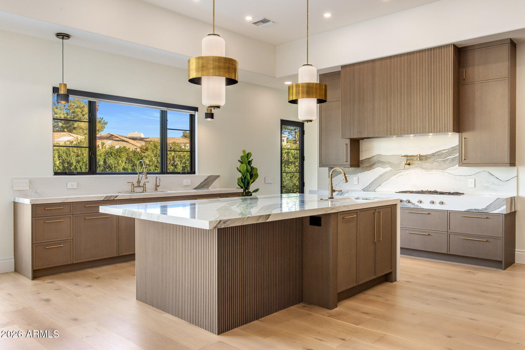 8625 Morning Glory Road Paradise Valley, AZ 85253 - Photo 14 of 52 a kitchen with kitchen island granite countertop a sink and a stove