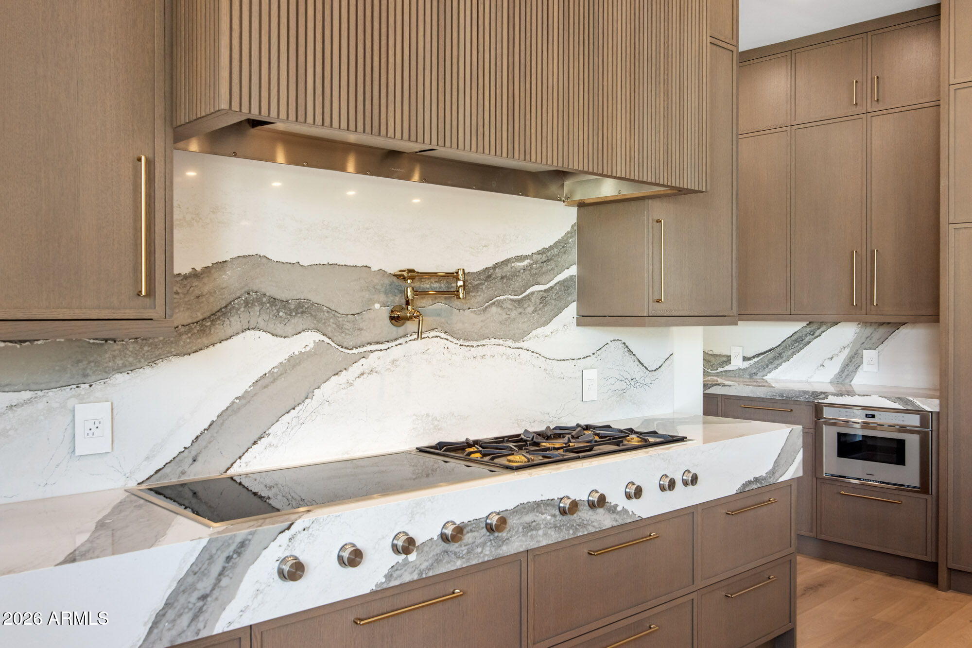 8625 Morning Glory Road Paradise Valley, AZ 85253 - Photo 15 of 52 a stove top oven sitting inside of a kitchen