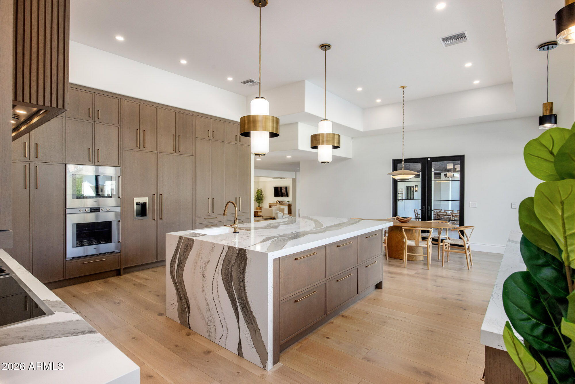 8625 Morning Glory Road Paradise Valley, AZ 85253 - Photo 16 of 52 a large kitchen with kitchen island a large island in it