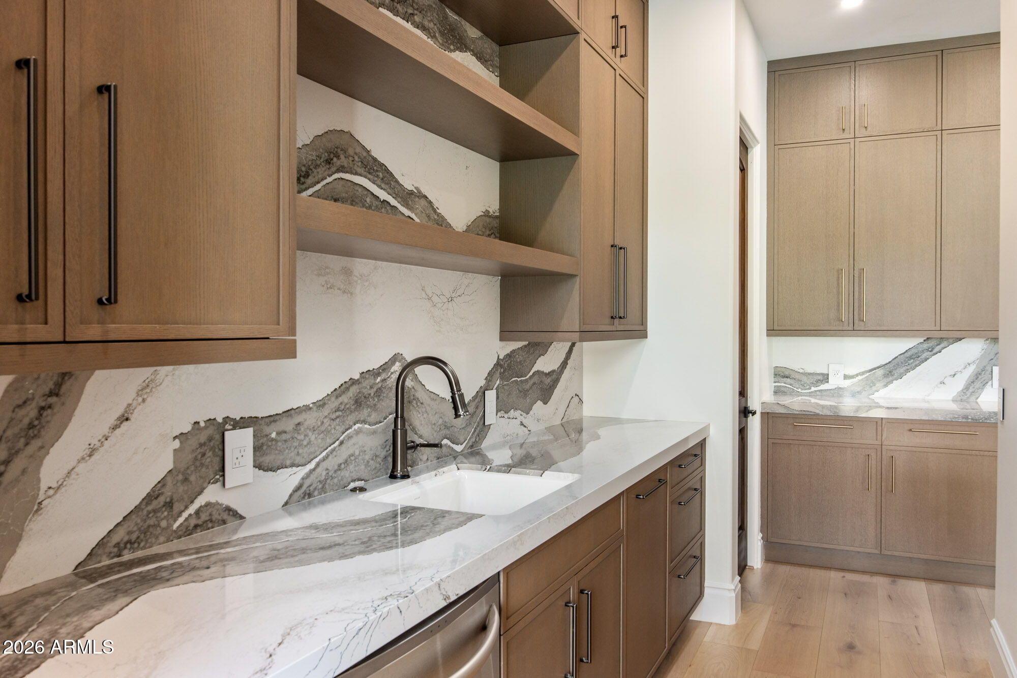 8625 Morning Glory Road Paradise Valley, AZ 85253 - Photo 19 of 52 a kitchen with a sink and cabinets
