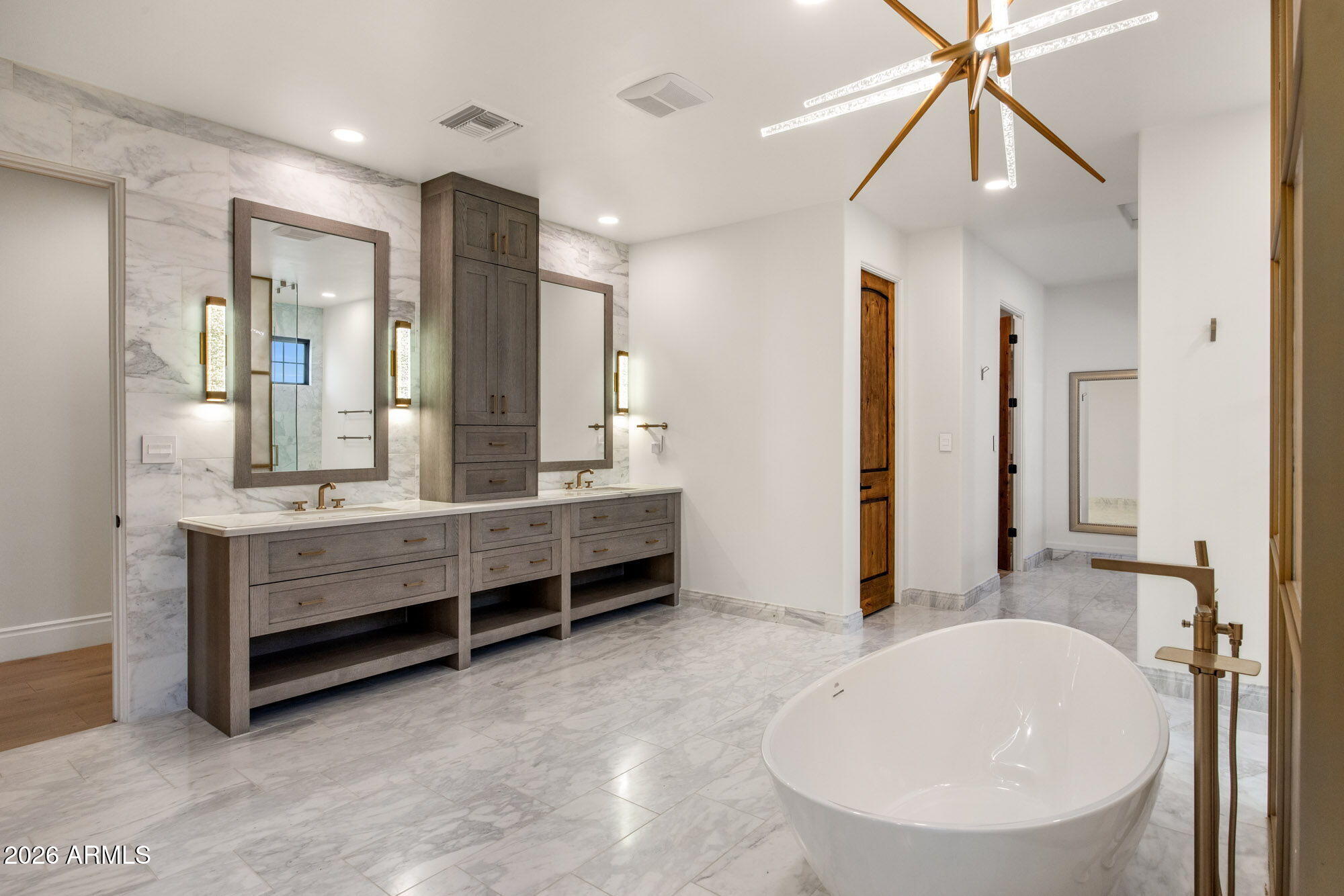 8625 Morning Glory Road Paradise Valley, AZ 85253 - Photo 22 of 52 a bathroom with a tub sink shower and mirror