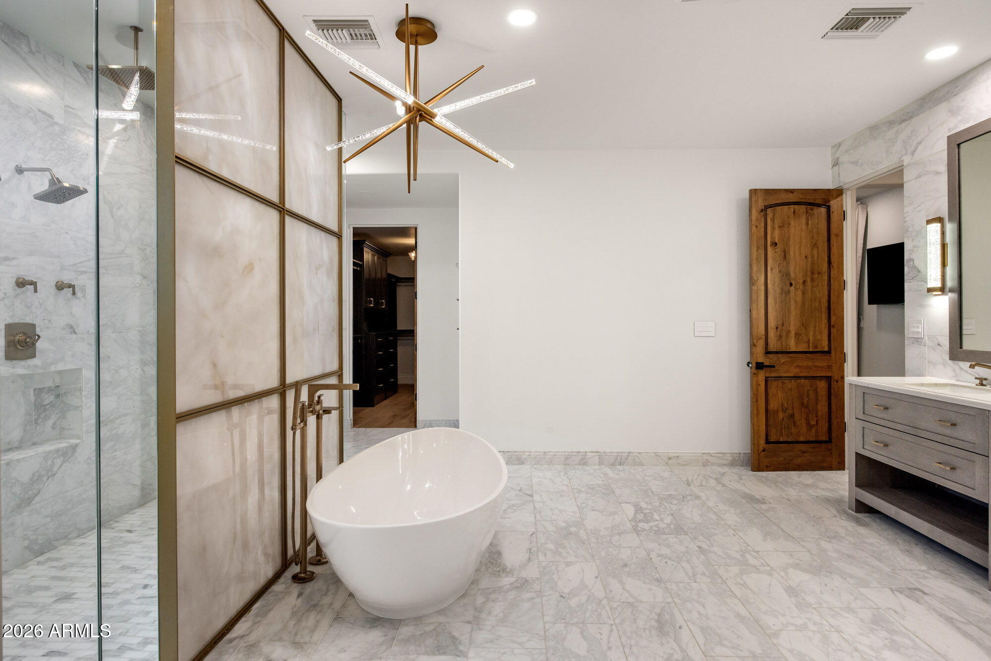8625 Morning Glory Road Paradise Valley, AZ 85253 - Photo 26 of 52 a bathroom with a white tub shower and closet