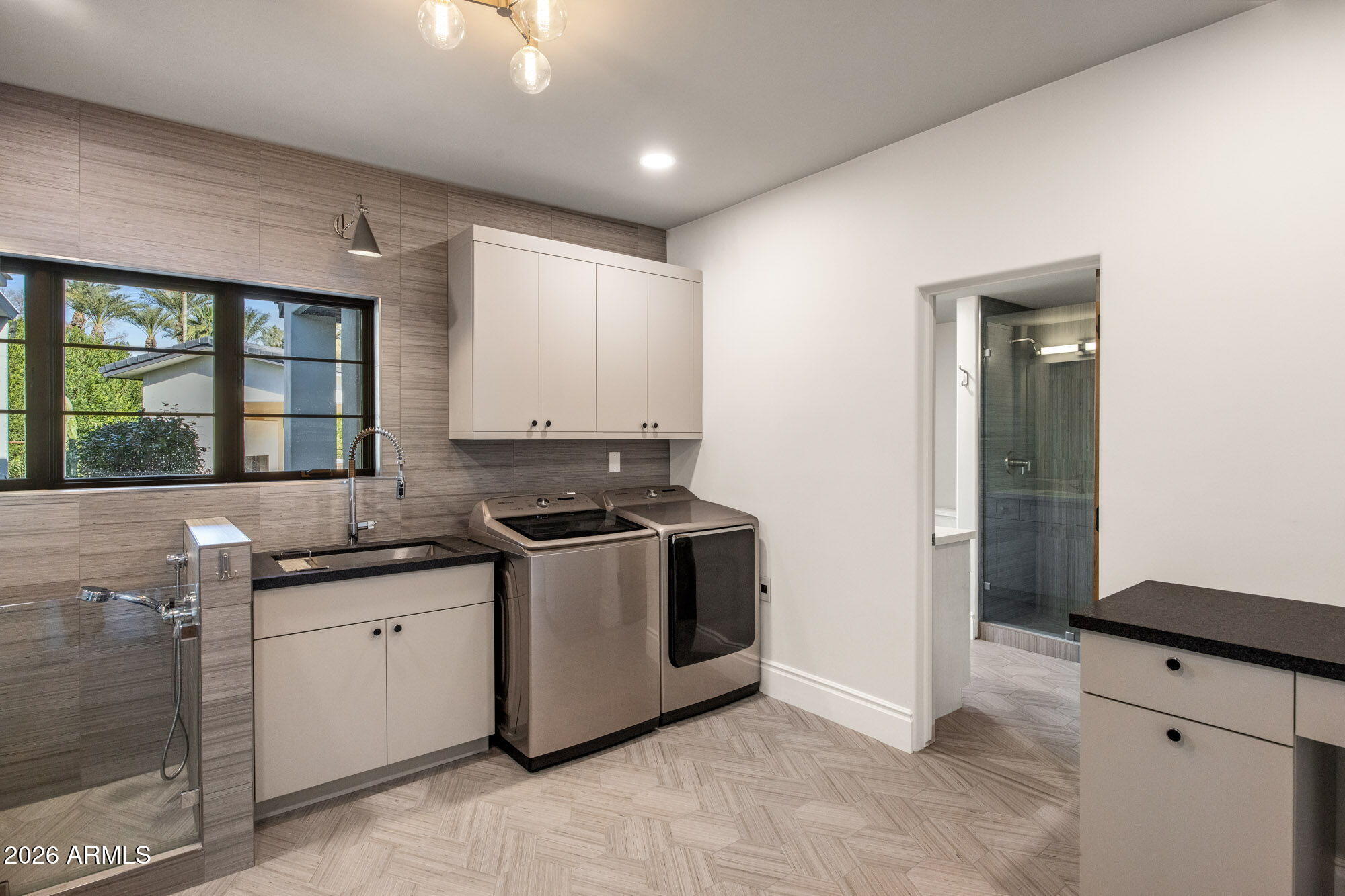 8625 Morning Glory Road Paradise Valley, AZ 85253 - Photo 31 of 52 a kitchen with stainless steel appliances granite countertop a sink and a stove next to a window