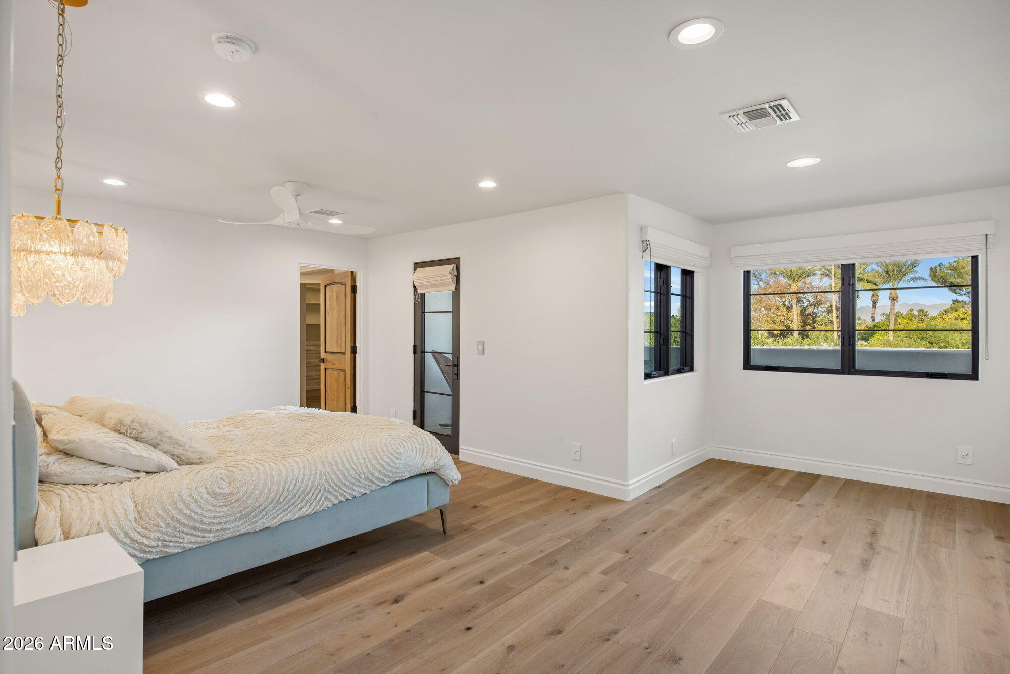 8625 Morning Glory Road Paradise Valley, AZ 85253 - Photo 36 of 52 a bedroom with a bed and painting on the wall