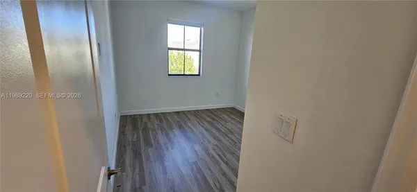 a view of an entryway with wooden floor