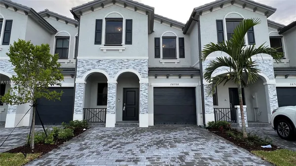a front view of a house with yard
