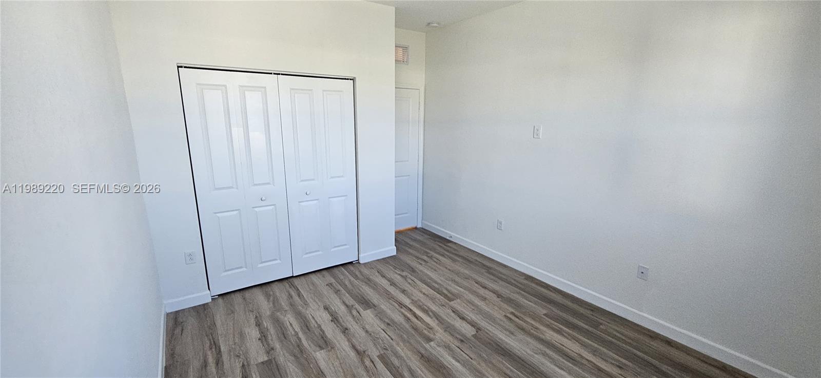 28708 Southwest 134th Court Homestead, FL 33033 - Photo 21 of 26 a view of an empty room with wooden floor
