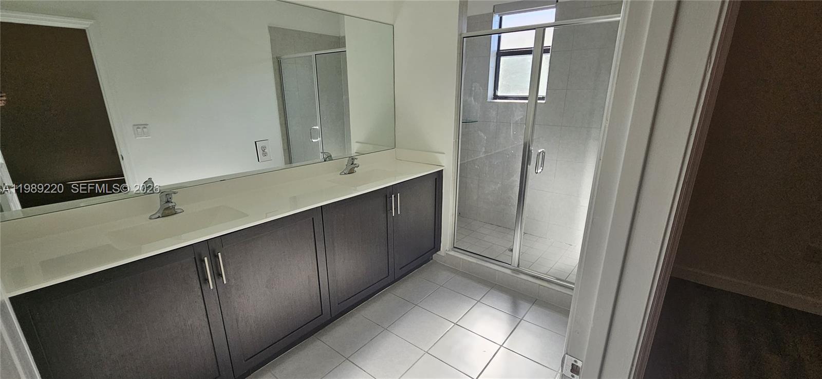 28708 Southwest 134th Court Homestead, FL 33033 - Photo 24 of 26 a bathroom with a double vanity sink and mirror