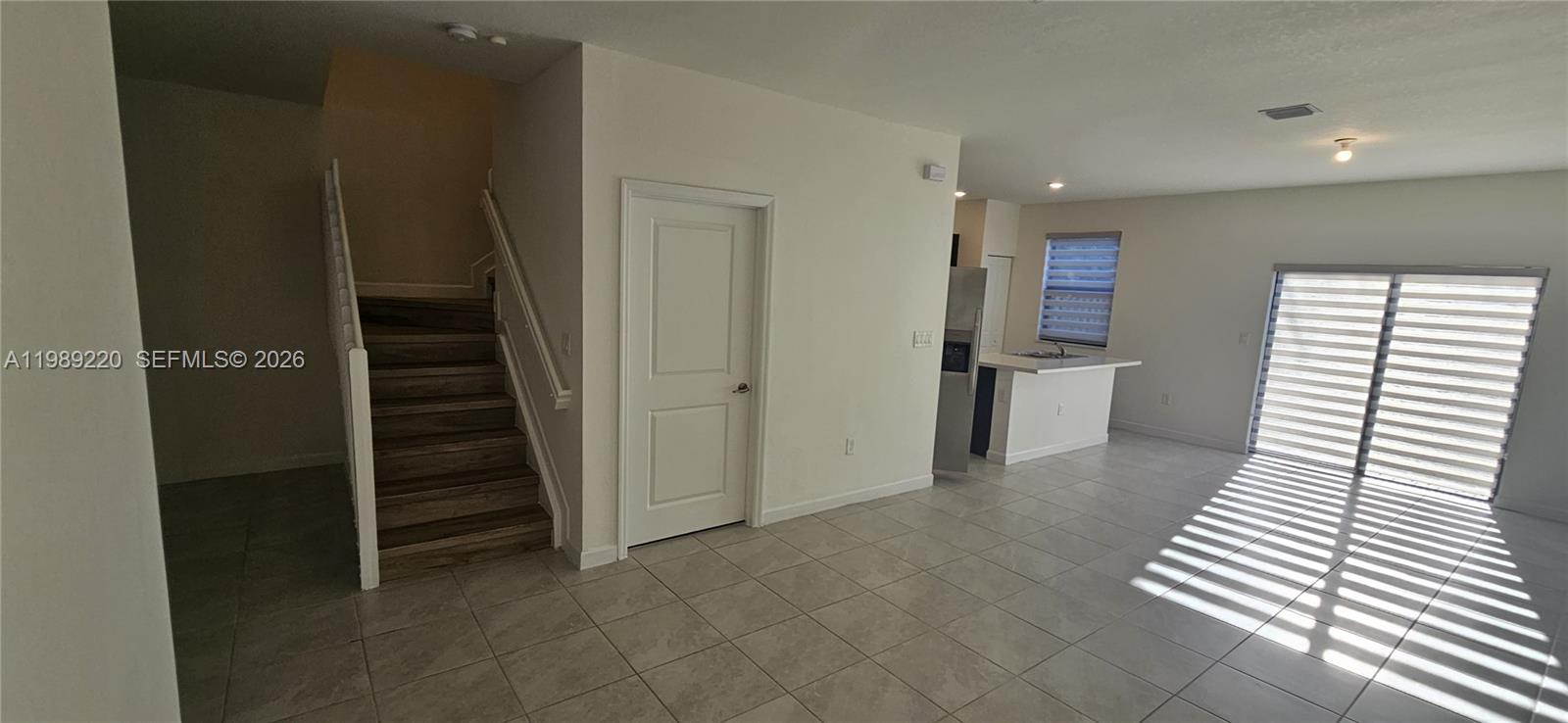 28708 Southwest 134th Court Homestead, FL 33033 - Photo 8 of 26 a view of a hallway with entryway and wooden floor