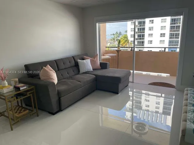 a living room with furniture and kitchen view