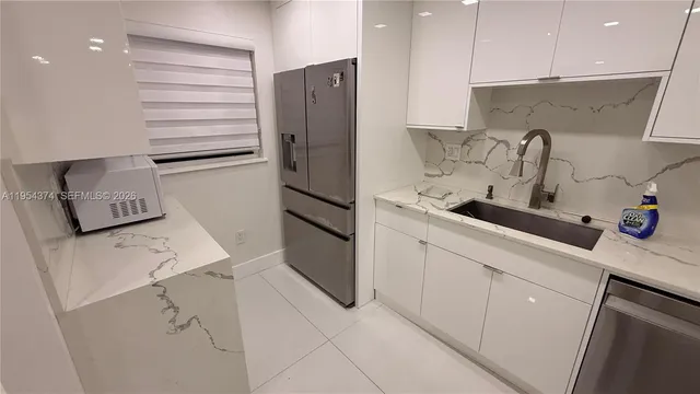 a kitchen with a sink and cabinets