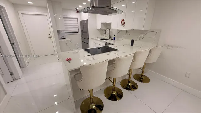 a kitchen with a refrigerator and a stove top oven