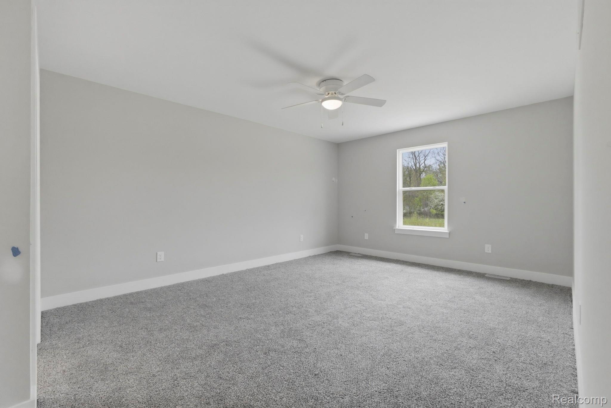 2281 Baltimore Davison, MI 48423 - Photo 12 of 26 Carpeted spare room featuring baseboards and a ceiling fan