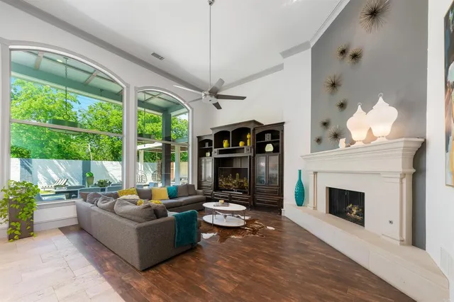 a living room with furniture large window and fireplace